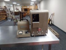 A vintage Bell and Howell model 601 movie projector with power supply.