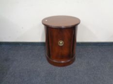 A reproduction cylindrical cabinet.