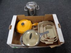 A box containing Le Creuset pans and oven dishes, an asparagus kettle.