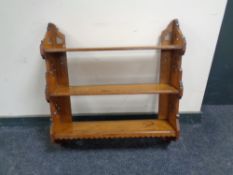 An antique pine three tier wall shelf.