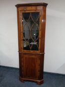 An inlaid mahogany corner cabinet.