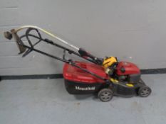 A Mountfield petrol lawnmower model RV40 together with a JCB petrol strimmer.