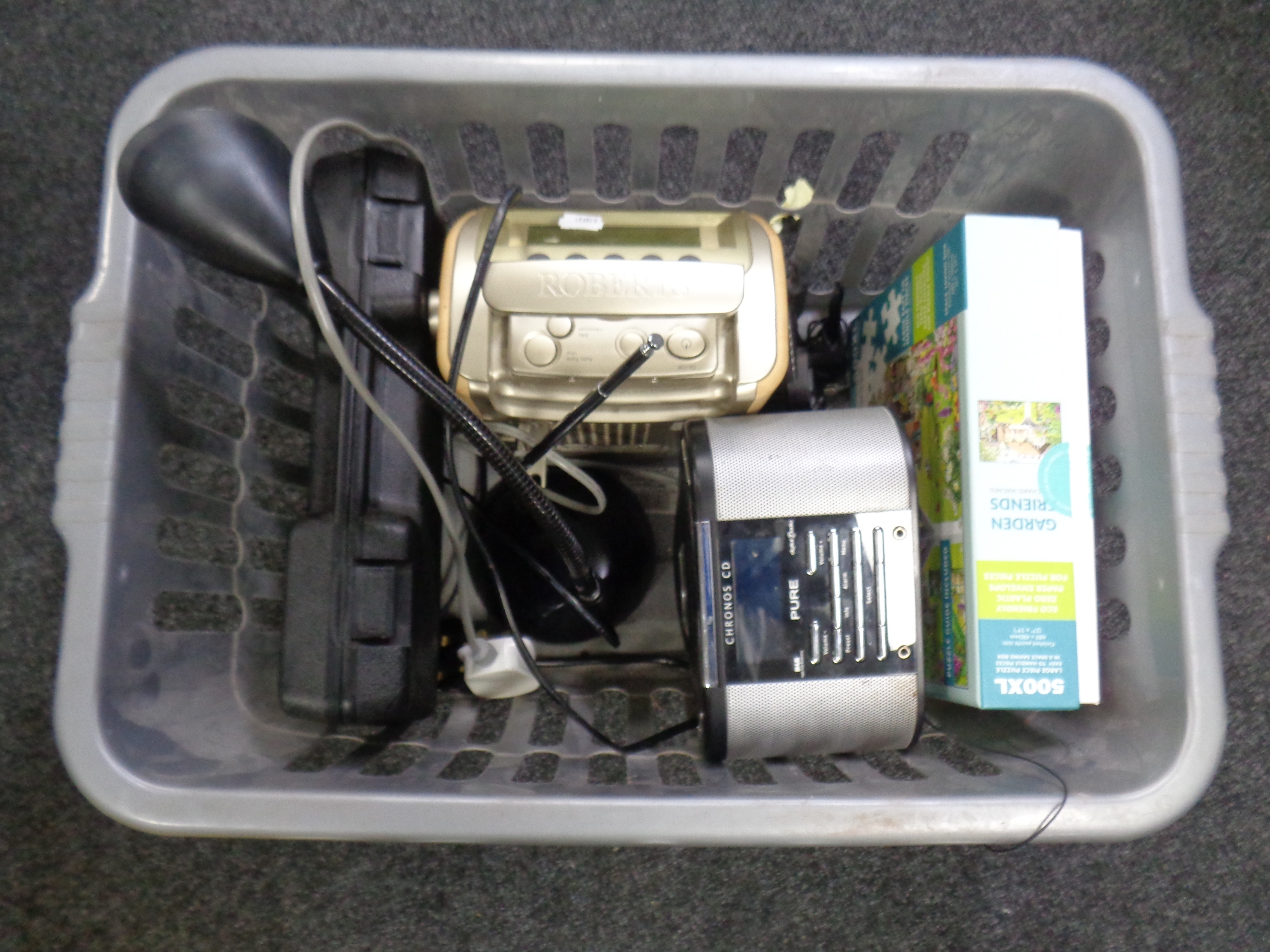 A crate containing Roberts DAB radio, a Pure CD player, jigsaw puzzle, table lamp etc.