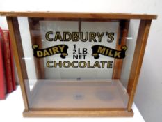 An early 20th century counter top display case bearing later Cadbury's advertising