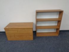 A pine effect shelf and storage cabinet.