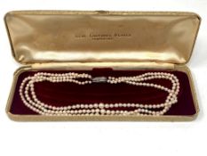 A three-row cultured pearl necklace