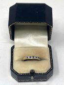 A diamond and sapphire half eternity ring