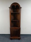 A reproduction mahogany corner cabinet.