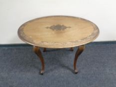 A continental carved mahogany oval occasional table.