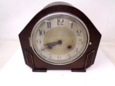 An Edwardian oak mantel clock.