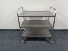 A three tier stainless steel trolley.