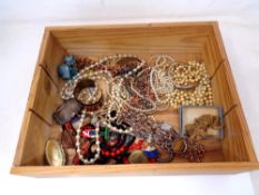 A pine box containing costume jewellery, military figures,