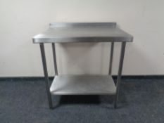 A stainless steel two tier preparation table.