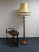 A mahogany standard lamp with shade together with a mahogany trolley.