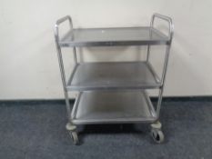 A stainless steel three tier preparation trolley.