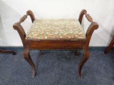 A beech storage piano stool.