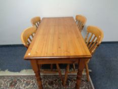 A pine kitchen table and four chairs.