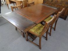 A six piece oak dining room suite comprising of buffet back sideboard,