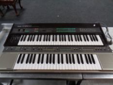 Two Yamaha electric keyboards model numbers DX9 and PS55.