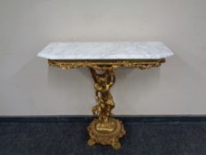 A marble topped gilded wooden console table.