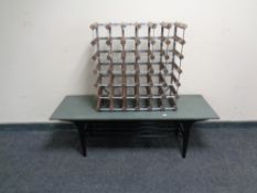 A mid-century coffee table with slate top together with a bottle rack.