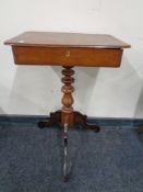 An antique mahogany work table.