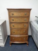 A reproduction mahogany five drawer chest.