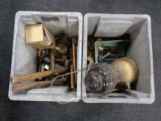 Two plastic crates containing hand tools, pair of candlesticks, a Tilley lamp.