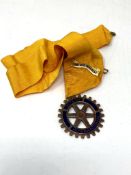 A Rotary International medallion on ribbon