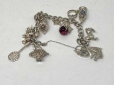 A silver charm bracelet with fourteen charms