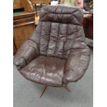 A 20th century continental brown leather swivel chair on rosewood effect base