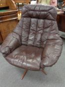 A 20th century continental brown leather swivel chair on rosewood effect base