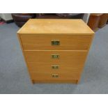 A continental teak effect chest of four drawers