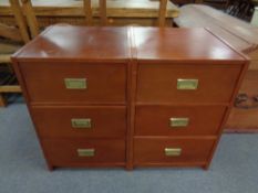 A pair of contemporary three drawer chests with brass drop handles