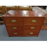 A pair of contemporary three drawer chests with brass drop handles