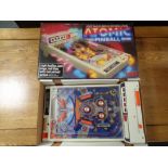A vintage Tomy Atomic Pinball (boxed) with a Philips clock radio