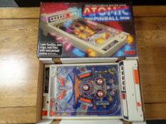 A vintage Tomy Atomic Pinball (boxed) with a Philips clock radio