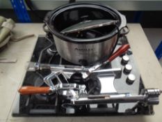 A cooker hob with 2 wall mounted wine bottle openers and a slow cooker