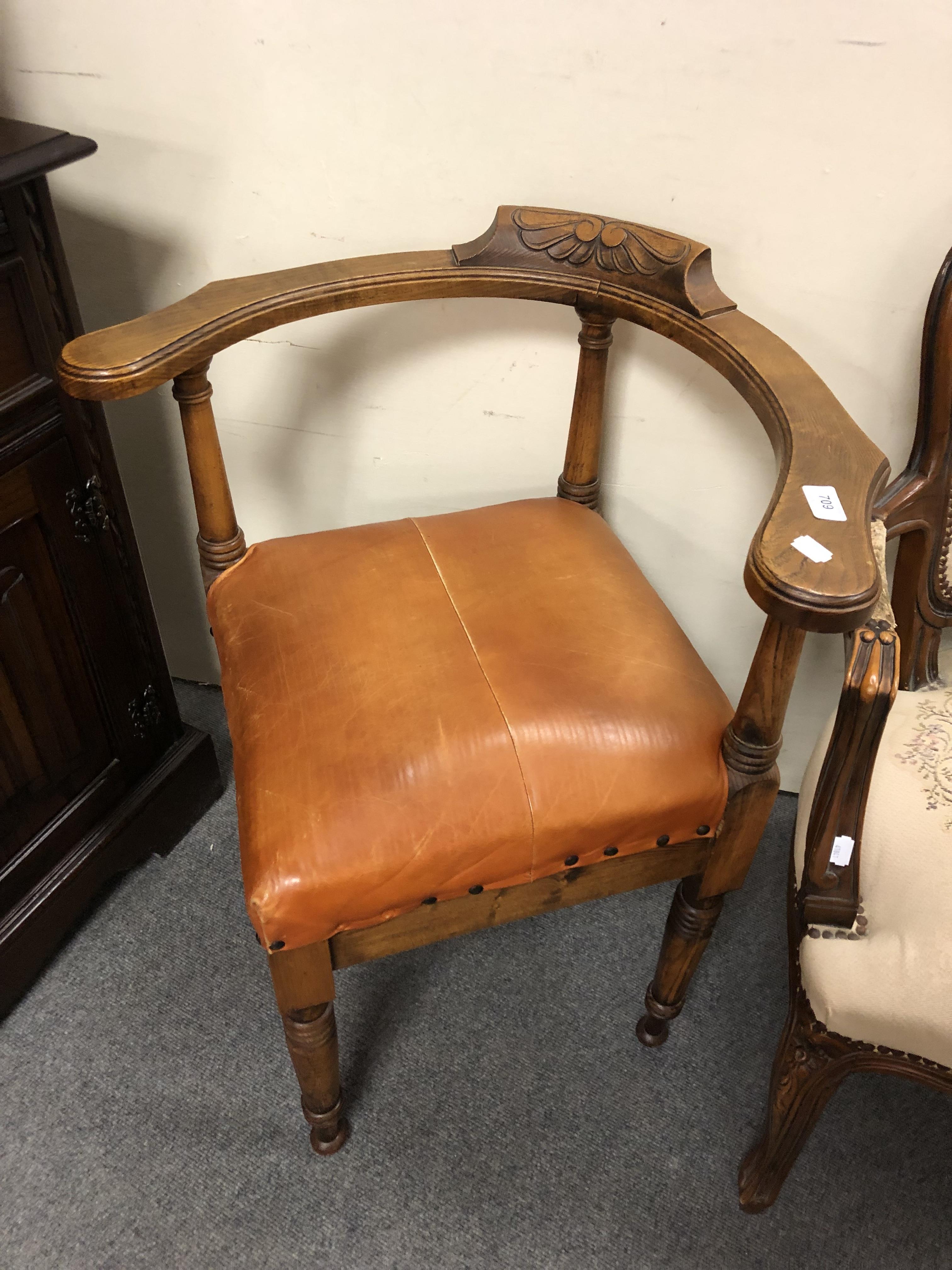 A beech and tan leather corner armchair