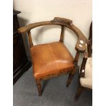 A beech and tan leather corner armchair