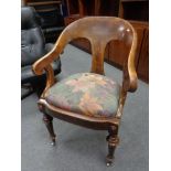 A 19th century continental walnut elbow chair