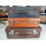 Three small vintage suitcases