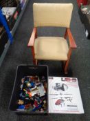 A childs armchair with a quantity of LEGO and a remote control helicopter