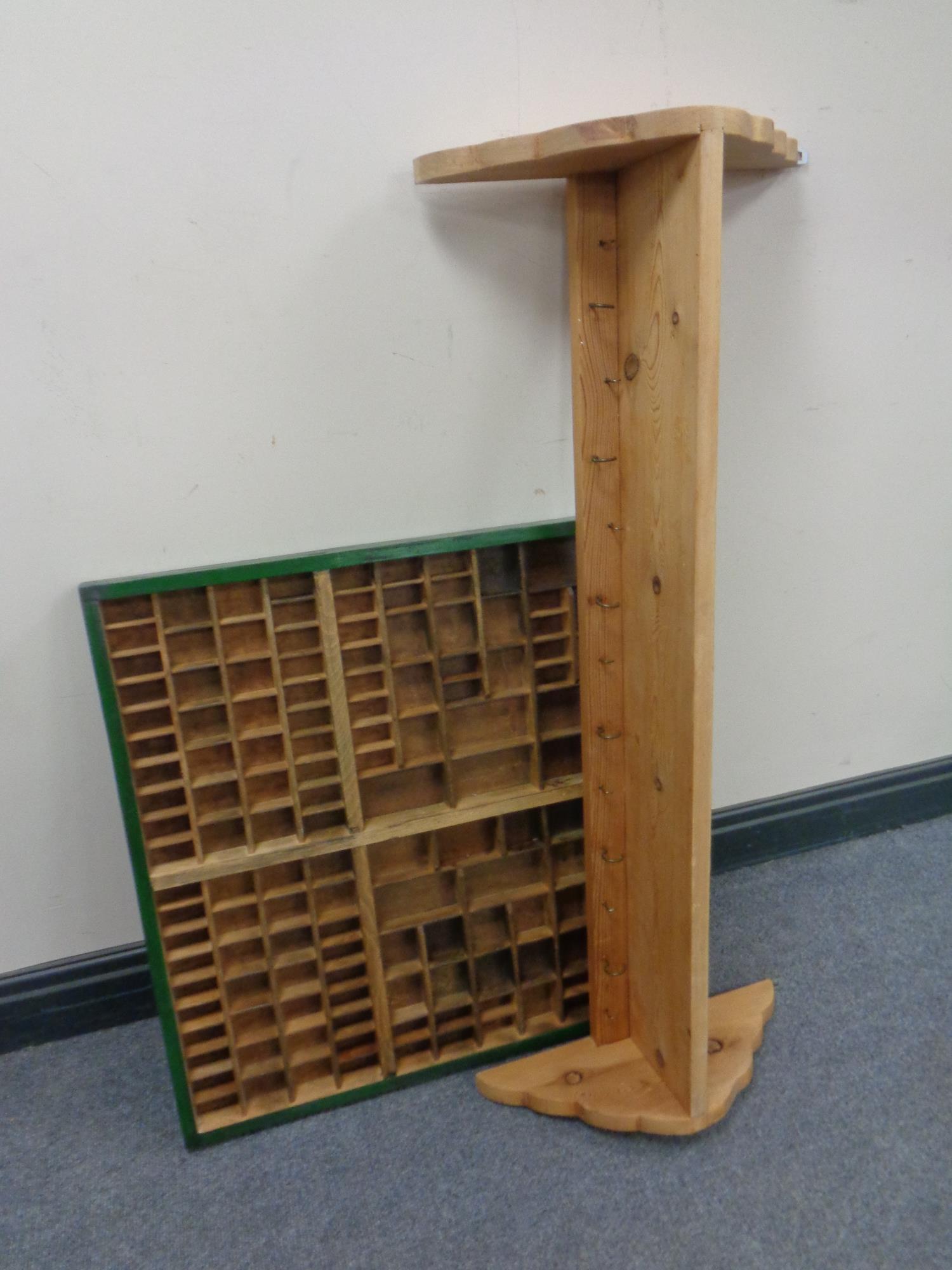 A pine coat rack together with a printer's type tray