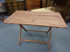 A stained teak rectangular garden table