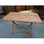 A stained teak rectangular garden table