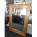 An overmantel mirror in heavy oak frame