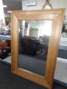 An overmantel mirror in heavy oak frame