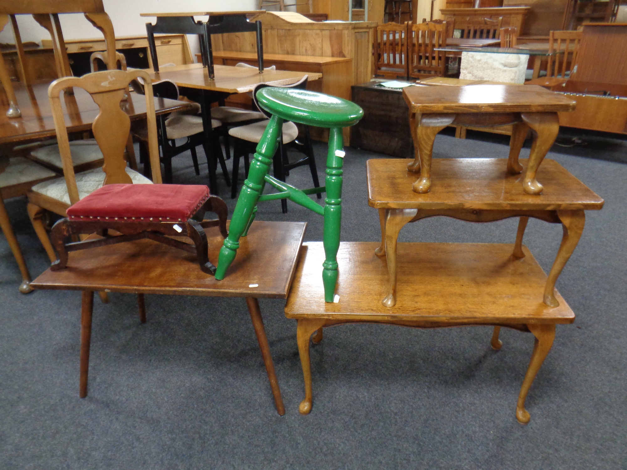 A group of occasional furniture comprising two stools,