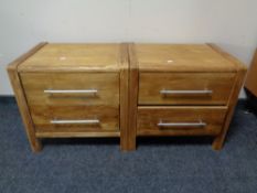 A pair of oak effect two drawer bedside chests